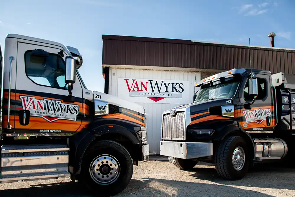 Learn about Van Wyks Inc. Two concrete trucks parked in front of the company’s facility in Waldo, Wisconsin.