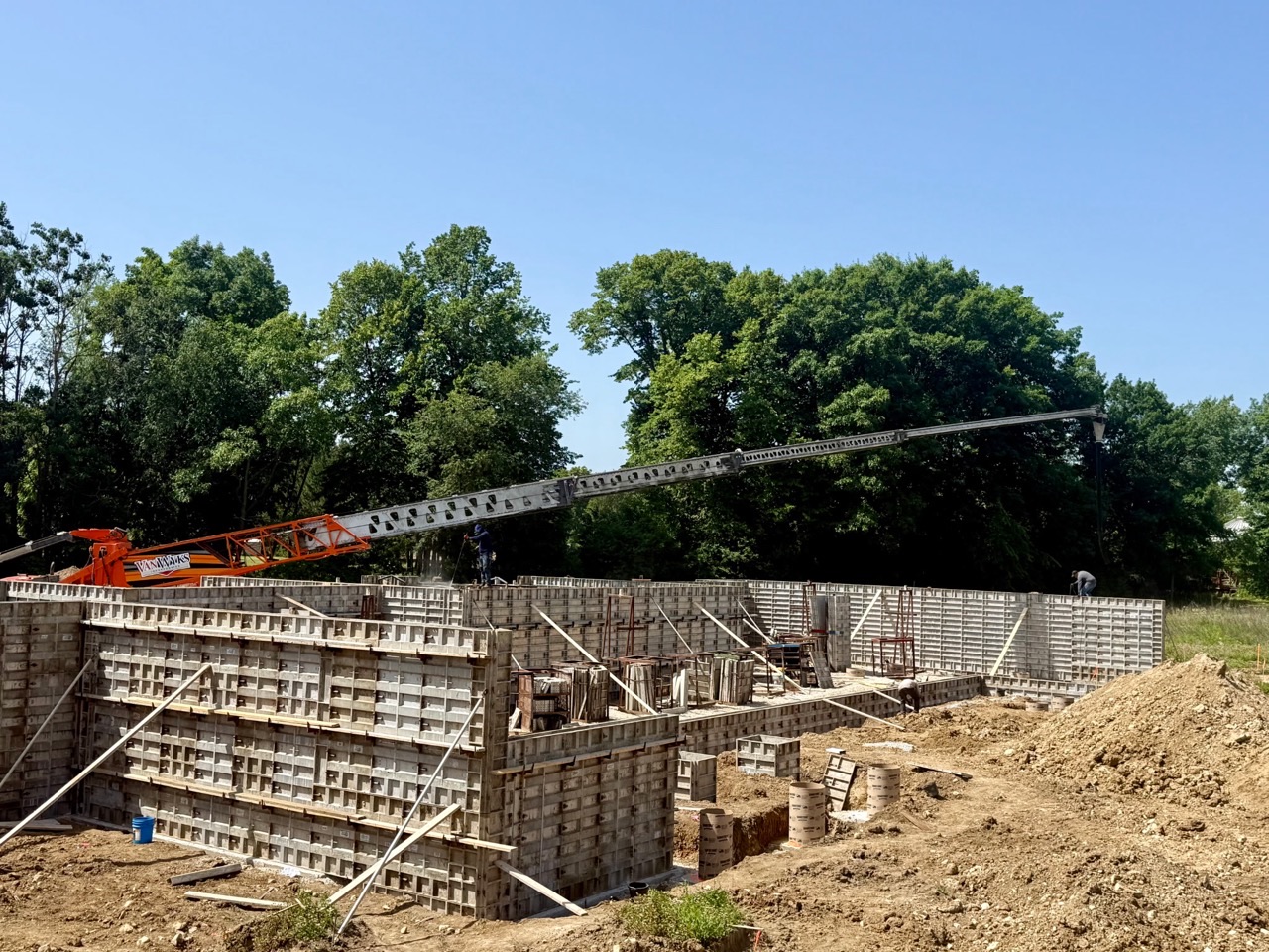 an Wyks Inc. using a 120-foot concrete boom to pour concrete walls for a new residential home in Eastern Wisconsin.